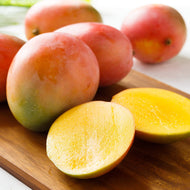 Bowen Mango on a board, one cut open